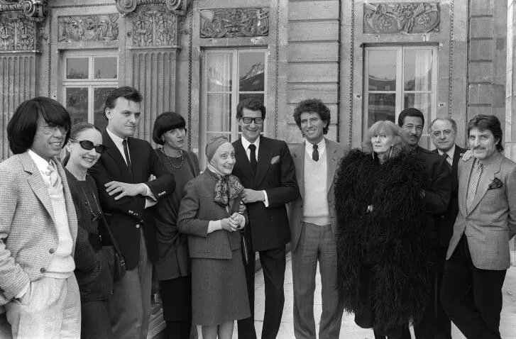 Issey Miyake (third from the right) with Kenzo Takada, Anne-Marie Beretta, Jean-Charles de Castelbajac, Chantal Thomass, Alix Gres, Yves Saint-Laurent, French Minister of Culture Jack Lang, Sonia Rykiel, Pierre Bergé and Emanuel Ungaro in 1984.  Credit:  PIERRE GUILLAUD/AFP/AFP/Getty Images